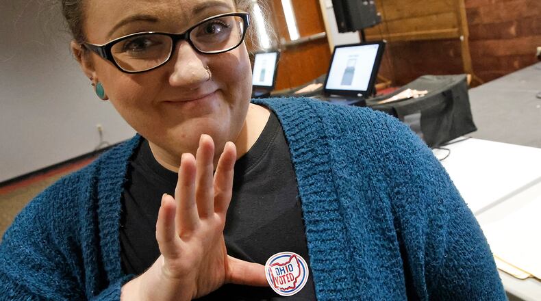 Margaret Kohli puts on her "Ohio Voted" sticker after voting at her voter pricinct at the First Christian Church on Middle Urbana Road Tuesday, March 19, 2024. BILL LACKEY/STAFF