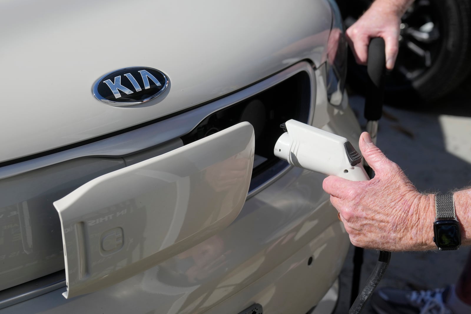 FILE - Ken Honeycutt demonstrates charging his Kia Soul electric vehicle in San Lorenzo, Calif., Nov. 9, 2024. (AP Photo/Jeff Chiu, File)