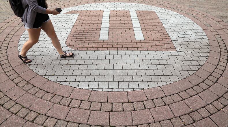 A student walks across campus at Wittenberg University, which is federally mandated to release a report annually about campus security and safety. BILL LACKEY/STAFF