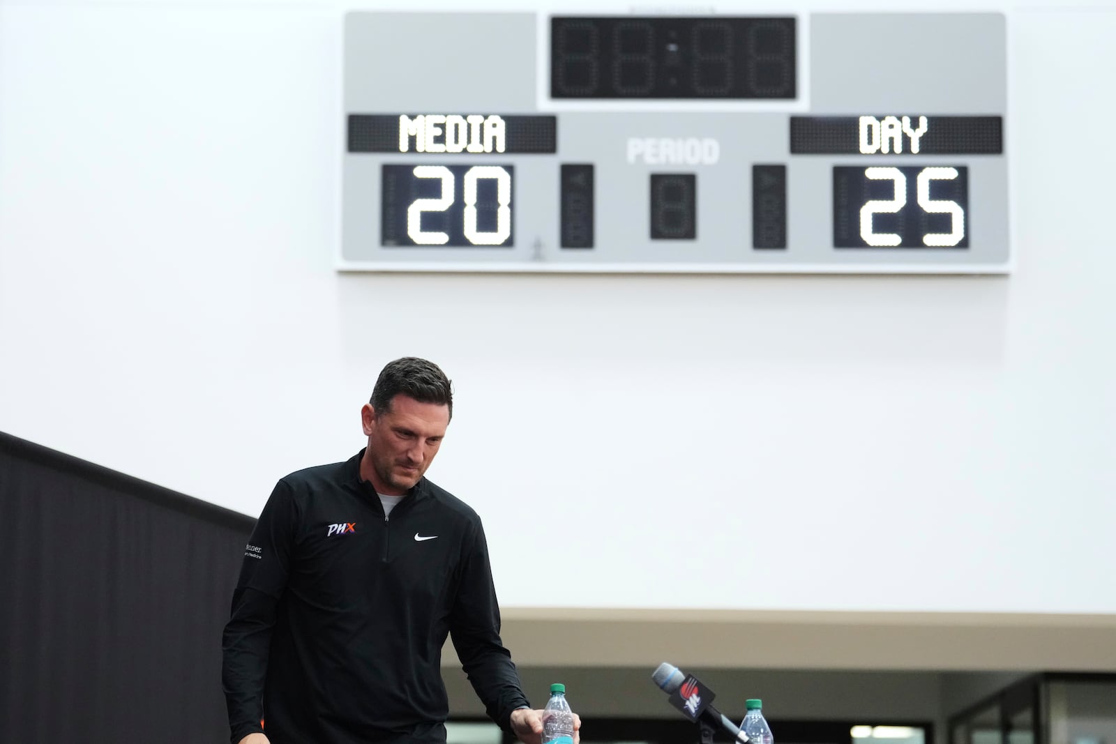 Phoenix Mercury head coach Nate Tibbetts arrives for a news conference during Mercury Media Day at the team's WNBA basketball training facility, Wednesday, April 30, 2025, in Phoenix. (AP Photo/Ross D. Franklin)