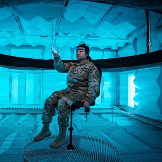 Second Lt. Hailey Ramos, human factors engineer, wears a motion capture headset as she identifies the direction of sound emitted from a circular array of speakers in the Spatial Hearing Anechoic Research Chamber Lab at Wright-Patterson Air Force Base, Sept. 11, 2025. Air Force photo/ Richard Eldridge