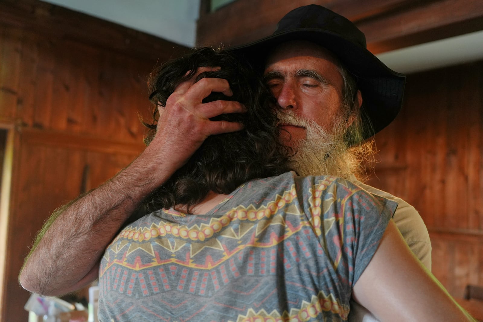 Stuart Sydenstricker, right, and Jules Wing Vasquez hug after completing a portion of the Quaker March to Washington at the Quaker Meeting House in Princeton, N.J. (AP Photo/Luis Andres Henao)