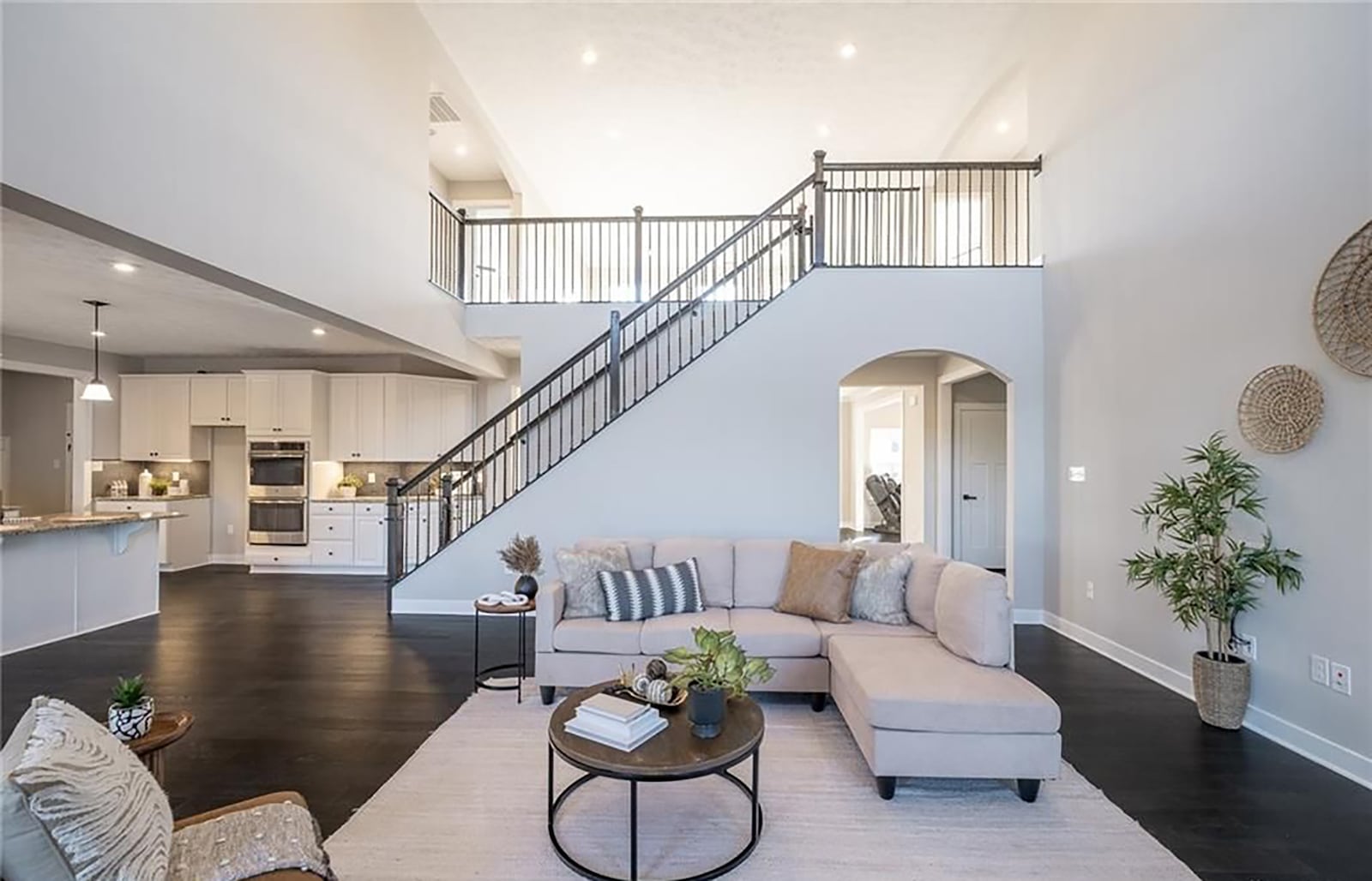 The staircase to the second floor is off the great room and leads up to the primary bedroom suite and three additional bedrooms and a loft. CONTRIBUTED