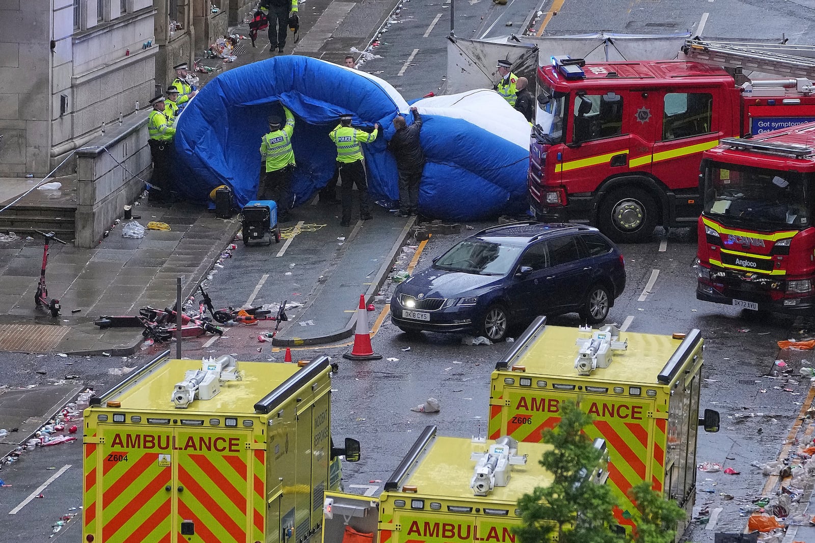 Police and emergency personnel deal with an incident after a car collided with pedestrians near the Liver Building during the Premier League winners parade in Liverpool, England, Monday, May 26, 2025.(AP Photo/Jon Super)