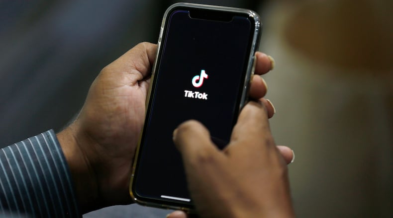 FILE - In this July 21, 2020 file photo, a man opens social media app 'TikTok' on his cell phone, in Islamabad, Pakistan. (AP Photo/Anjum Naveed, File)