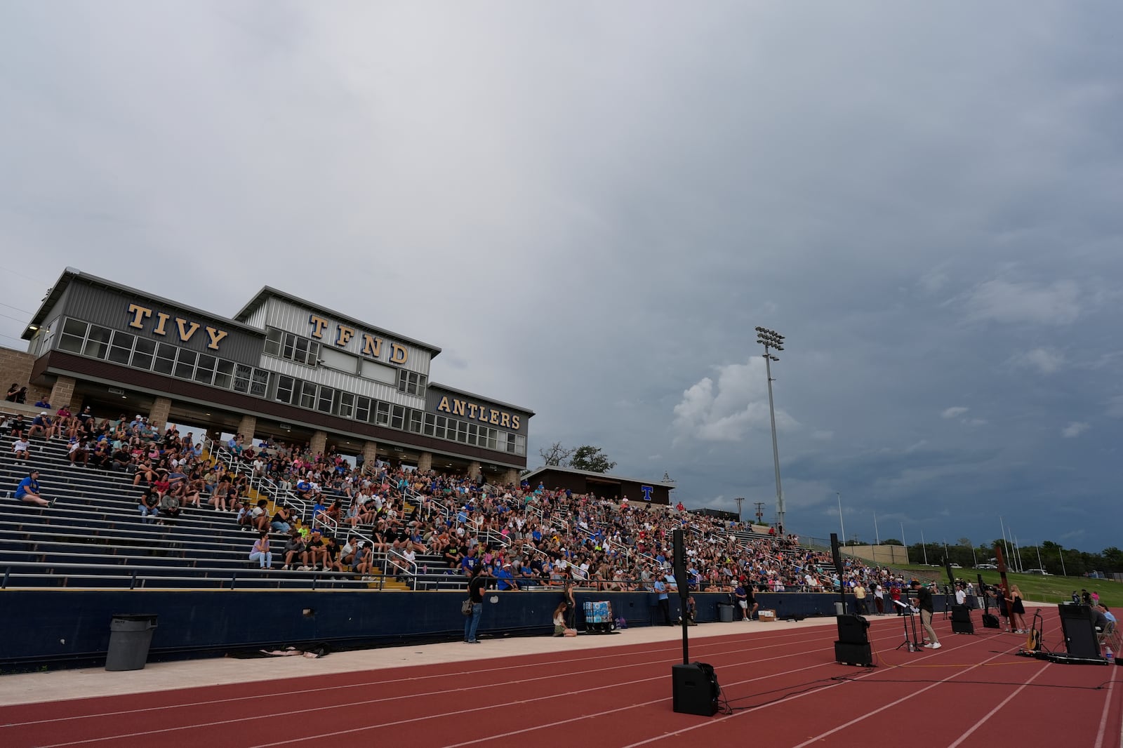 Clouds move in during a vigil for flooding victims at Tivy Antler Stadium on Wednesday, July 9, 2025, in Kerrville, Texas. (AP Photo/Ashley Landis)