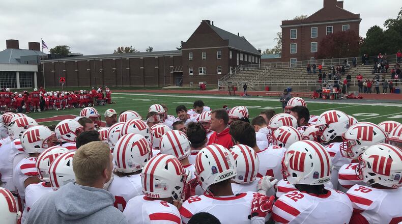 Wittenberg huddles around Joe Fincham after a victory at Wabash on Saturday, Oct. 28, 2017, in Crawfordsville, Ind.