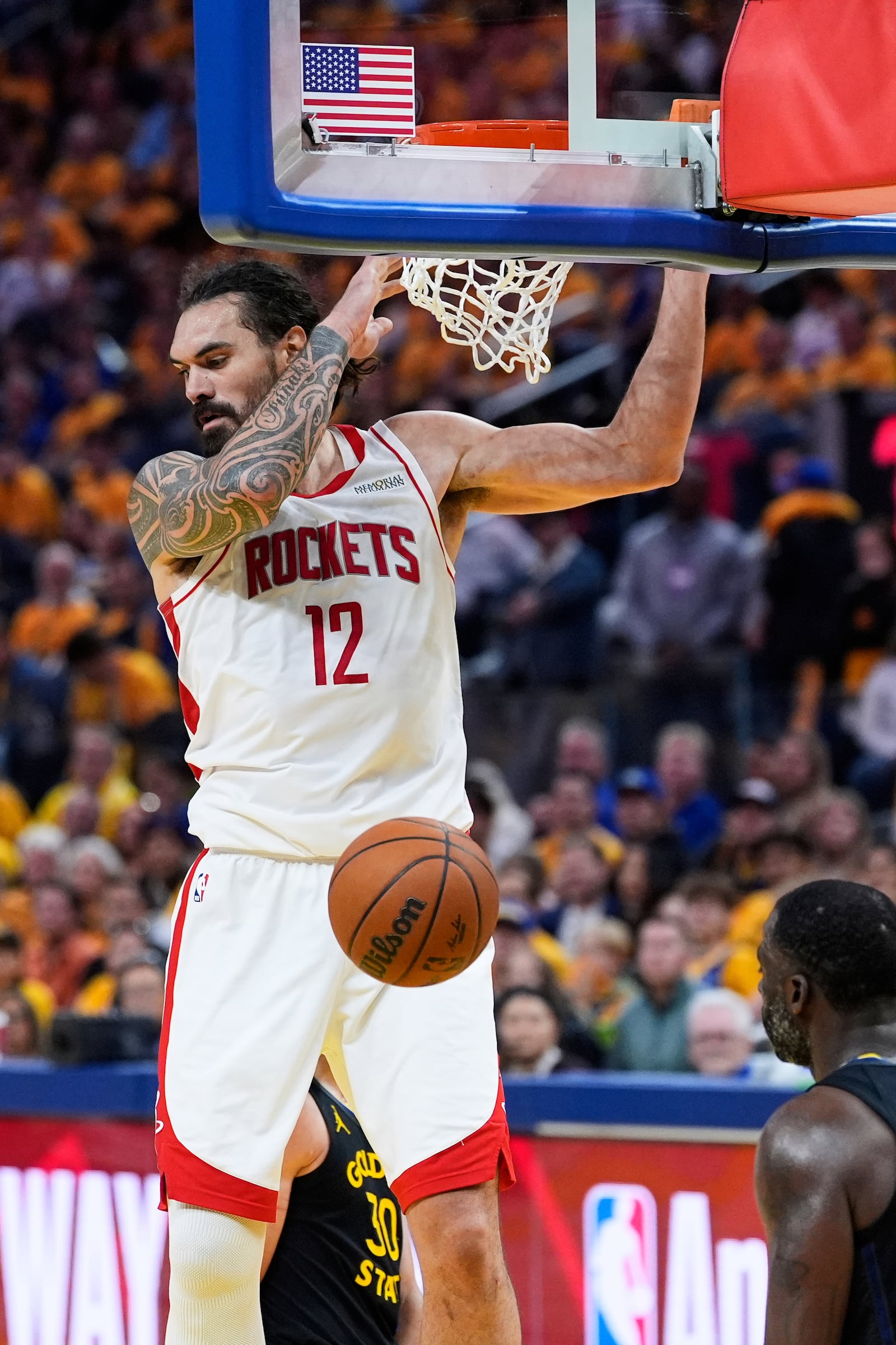 Houston Rockets center Steven Adams (12) dunks in front of Golden State Warriors forward Draymond Green during the second half of Game 6 of an NBA basketball first-round playoff series Friday, May 2, 2025, in San Francisco. (AP Photo/Godofredo A. Vásquez)