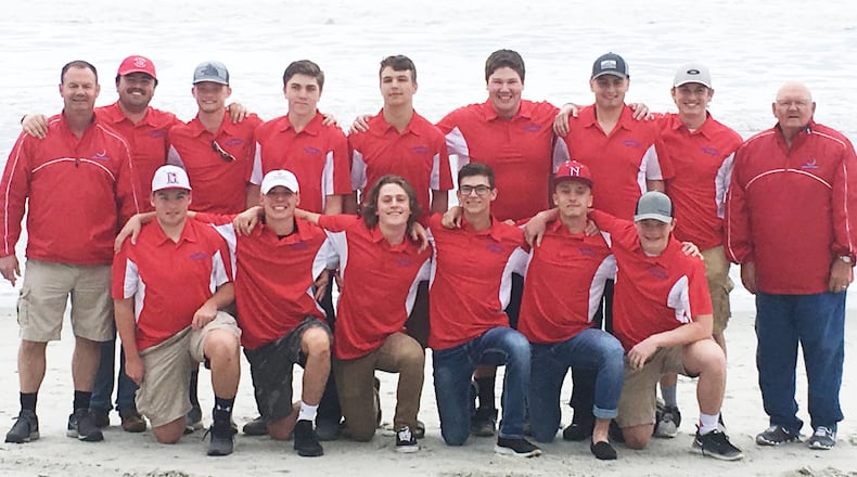 Northwestern baseball coach Todd Houseman gives pitcher Jake Parks a high-five after getting out of a jam during a game last week at Myrtle Beach, S.C. Northwestern defeated Robert Lee (Va.) 15-5. CONTRIBUTED PHOTO