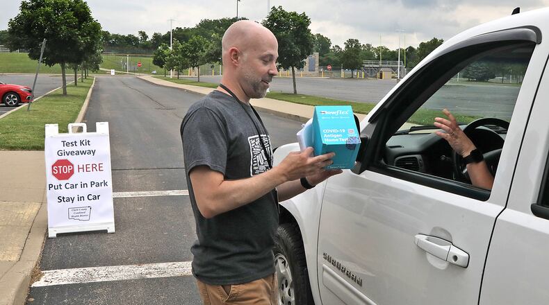 Chris Cook, Clark County Health Commissioner, is seen in this June 7, 2022 file photo handing out COVID-19 home test kits in a drive-thru set up in the parking lot at Springfield High School. BILL LACKEY/STAFF