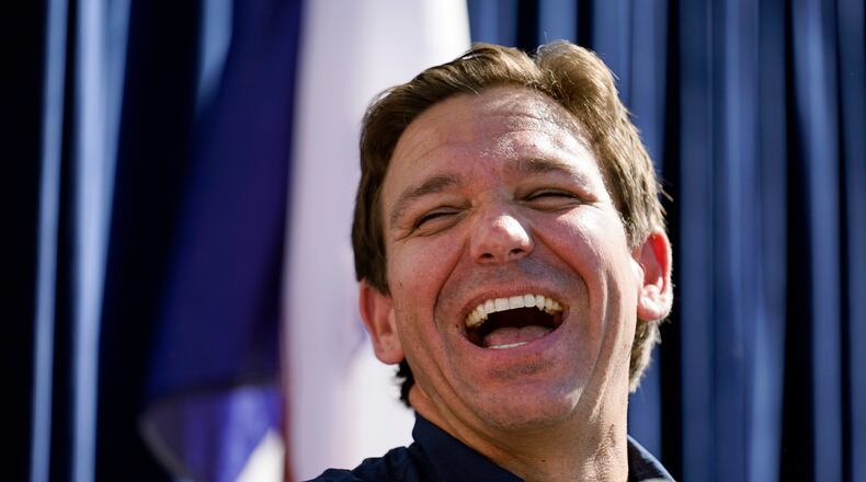 FILE - Republican presidential candidate Florida Gov. Ron DeSantis laughs at the Iowa State Fair, Aug. 12, 2023, in Des Moines, Iowa. (AP Photo/Jeff Roberson, File)