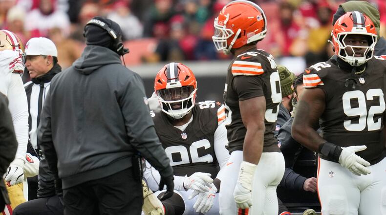 FILE - Cleveland Browns defensive tackle Maliek Collins, middle, is carted off the field during the second half of an NFL football game against the San Francisco 49ers, Nov. 30, 2025, in Cleveland. (AP Photo/Sue Ogrocki, file)