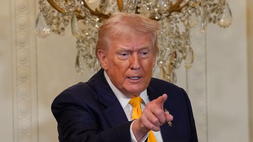 President Donald Trump gestures during a Black History Month event in the East Room of the White House, Wednesday, Feb. 18, 2026, in Washington. (AP Photo/Nathan Howard)