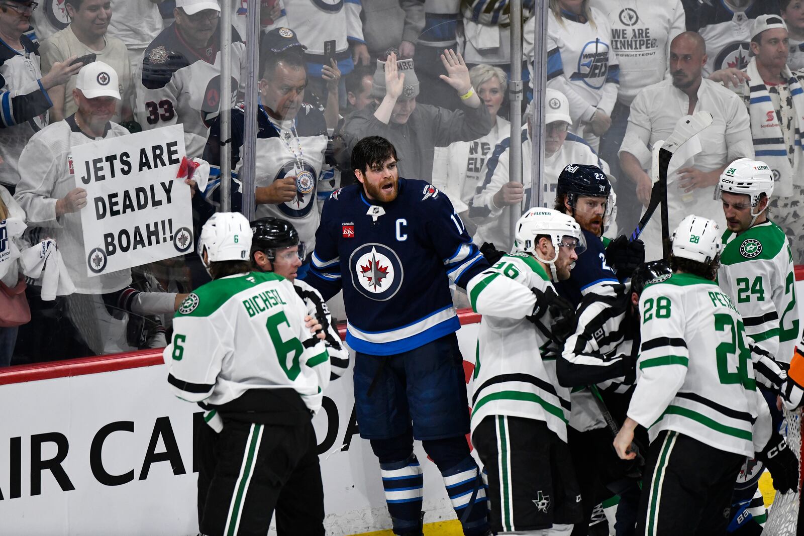 Winnipeg Jets' Adam Lowry (17) and Dallas Stars players push and shove at the end of a play during third period NHL playoff hockey action in Winnipeg, Thursday, May 15, 2025. (Fred Greenslade/The Canadian Press via AP)
