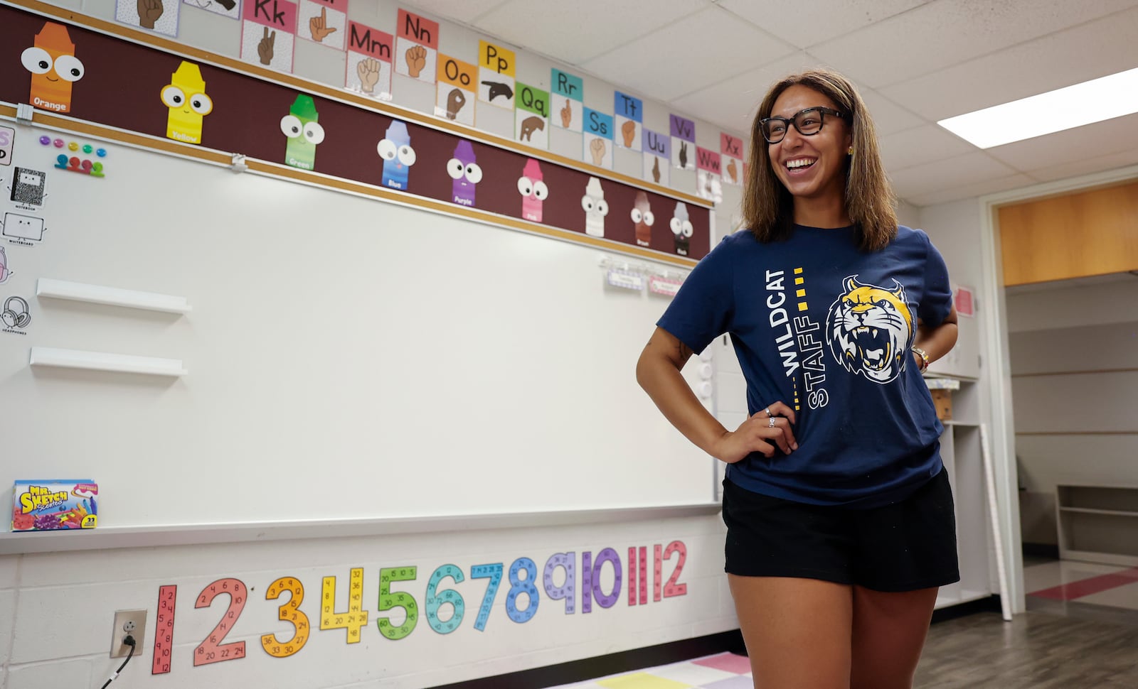 New first grade teacher Jenee' Jolly laughs as her sister tells her a joke while helping her set up her classroom at Lincoln Elementary School on Wednesday, August 6, 2025, in Springfield. She's a recent graduate of Wright State University. JOSEPH COOKE/STAFF