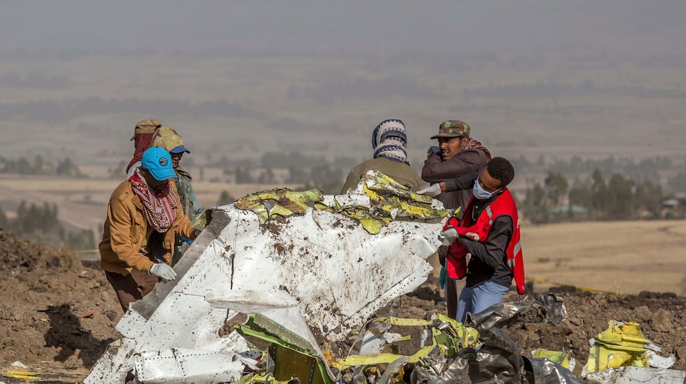 FILE - In this March 11, 2019, file photo, rescuers work at the scene of an Ethiopian Airlines flight crash near Bishoftu, Ethiopia. Pilot Bernd Kai von Hoesslin pleaded with his bosses for more training on the Boeing Max, just weeks before the Ethiopian Airline's jet crashed, killing everyone on board. (AP Photo/Mulugeta Ayene, File)