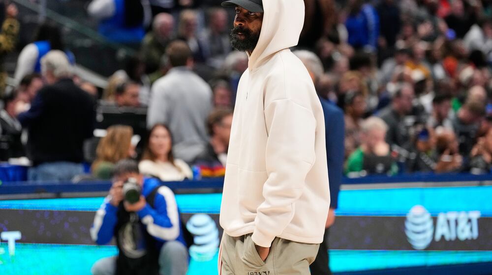 Dallas Mavericks guard Kyrie Irving stands on the court during a time ou in the second half of an NBA basketball game againt the Minnesota Timberwolves Wednesday, Jan. 28, 2026, in Dallas. (AP Photo/Tony Gutierrez)