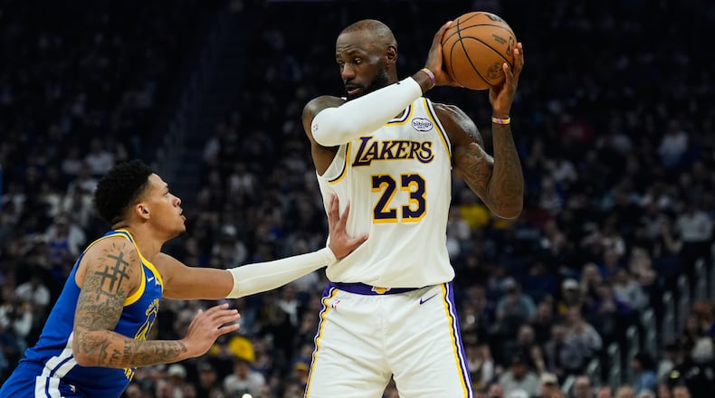 Los Angeles Lakers forward LeBron James (23) moves the ball while defended by Golden State Warriors guard Will Richard (3) during the first half of an NBA basketball game, Saturday, Feb. 28, 2026, in San Francisco. (AP Photo/Godofredo A. Vásquez)