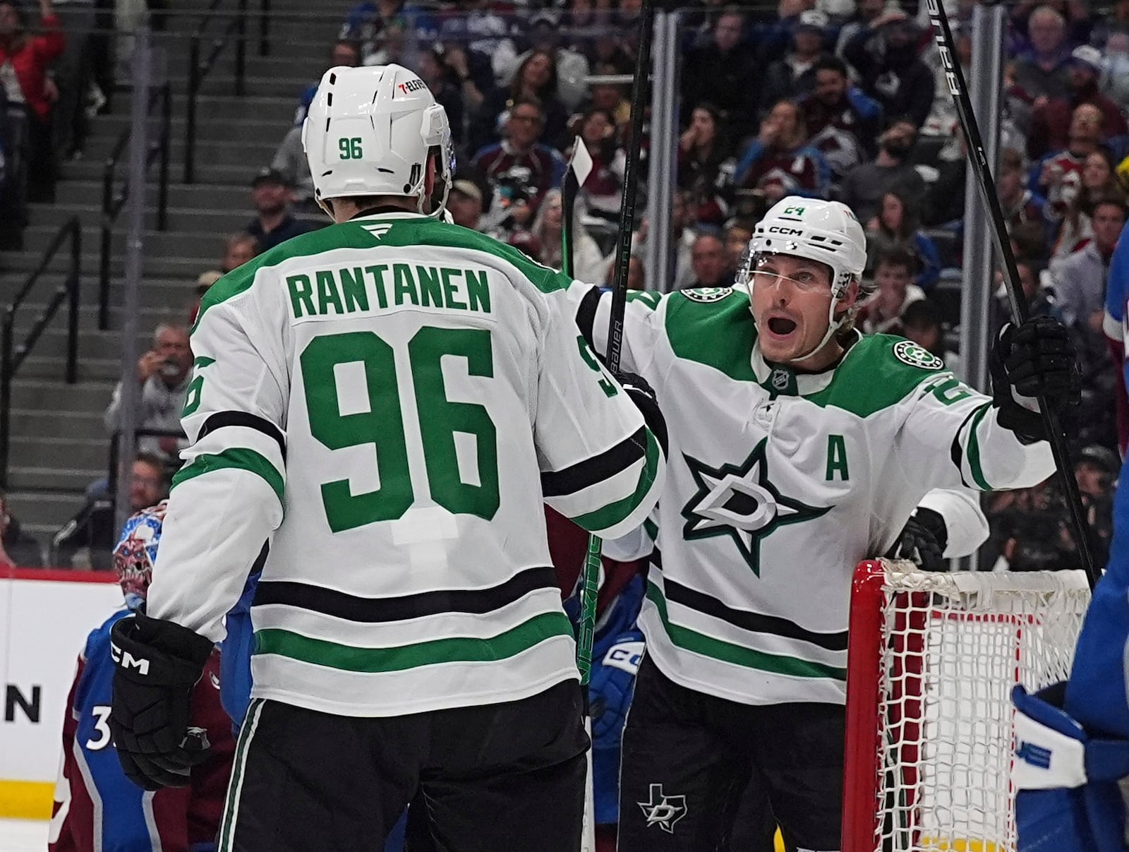 Dallas Stars right wing Mikko Rantanen (96) congratulates center Roope Hintz, after, after his goal in the second period of Game 6 of an NHL first-round hockey playoff series against the Colorado Avalanche, Thursday, May 1, 2025, in Denver. (AP Photo/David Zalubowski)