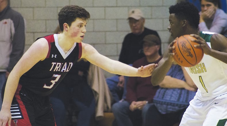 Triad’s Hadley LeVan (left) defends against Catholic Central’s Mykah Eichie during Tuesday night’s game in Springfield. Central won 64-56. JEFF GILBERT / CONTRIBUED