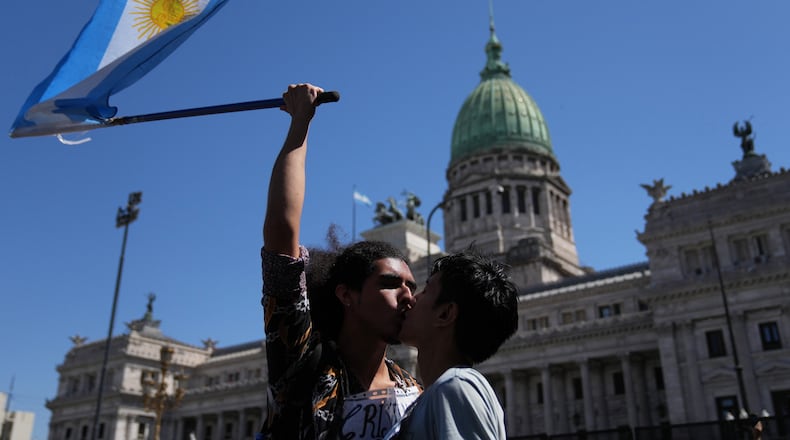 Cristian Valderrama kisses his husband Lucas Garcia during a protest outside Congress against a labor reform bill proposed by President Javier Milei's government in Buenos Aires, Argentina, Friday, Feb. 27, 2026. (AP Photo/Rodrigo Abd)