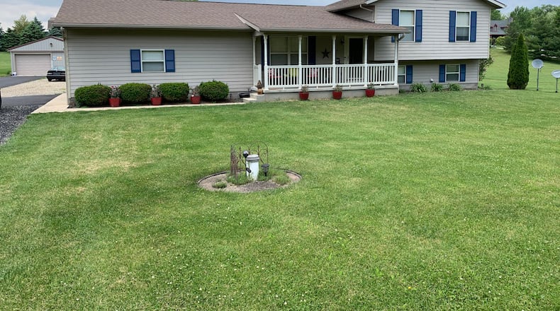 The front of this tri-level at 6586 Plattsburg Rd. in South Charleston features a large covered front porch and walkway leading from extended driveway. Beth Anspach/CONTRIBUTED