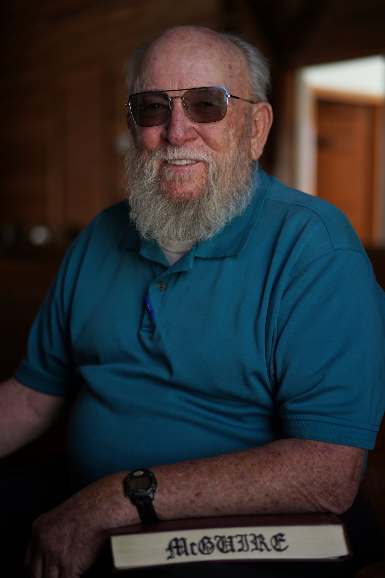 Oscar McGuire poses for a portrait with his copy of "The Sacred Harp" songbook at Holly Springs Primitive Baptist Church in Bremen, Ga., on Saturday, March 22, 2025. (AP Photo/Jessie Wardarski)