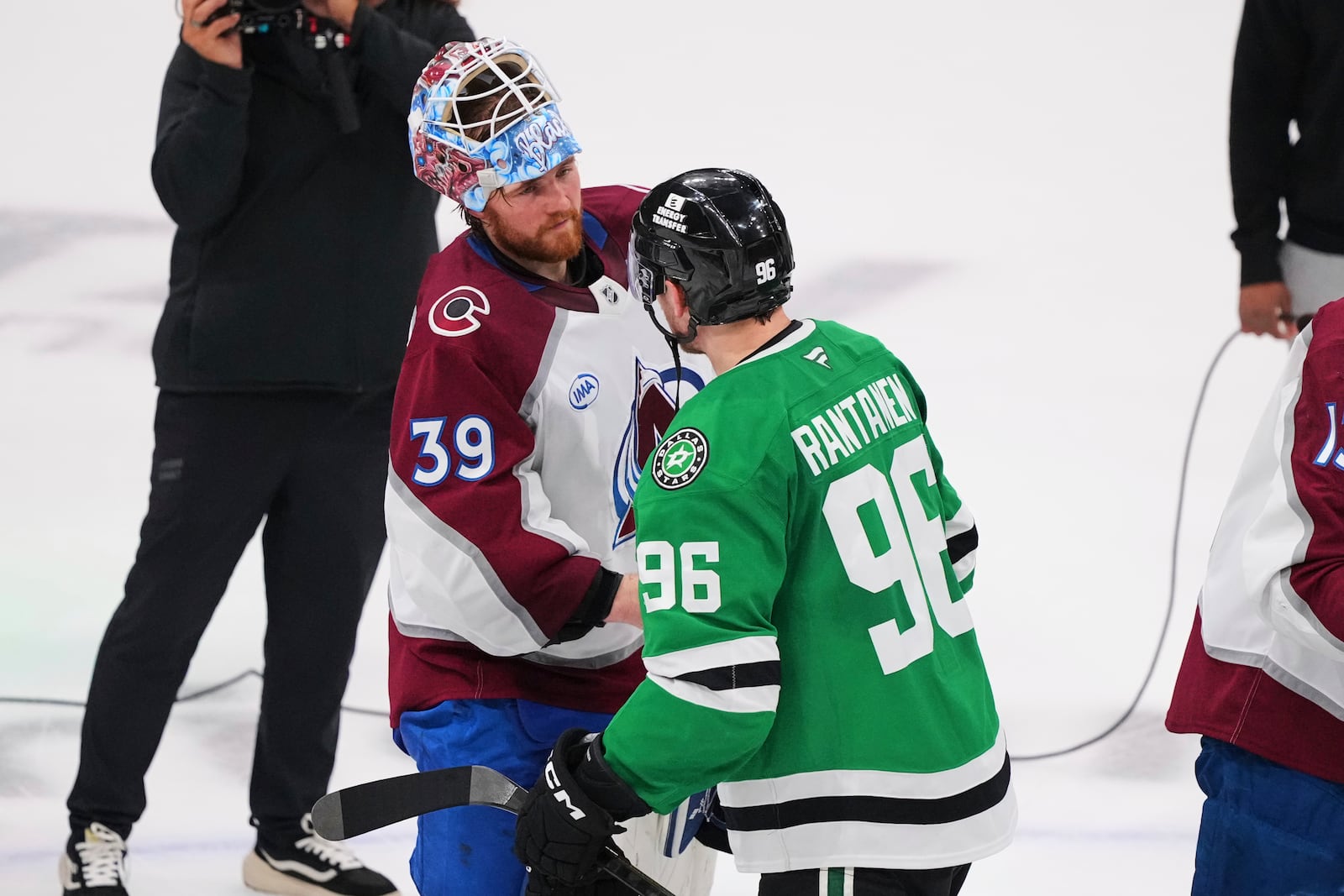 Colorado Avalanche's Mackenzie Blackwood (39) and Dallas Stars' Mikko Rantanen (96) shake hands after the Stars 4-2 win in Game 7 of a first-round NHL hockey playoff series Saturday, May 3, 2025, in Dallas. (AP Photo/Julio Cortez)