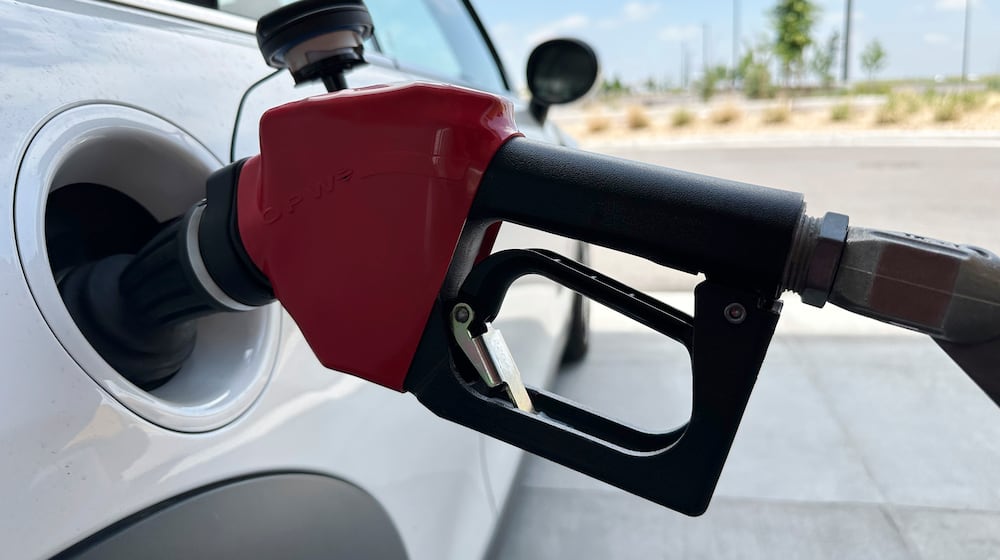 A motorist fills up the tank of a vehicle at a gasoline pump at a Costco warehouse Friday, May 31, 2024, in Aurora, Colo. (AP Photo/David Zalubowski)