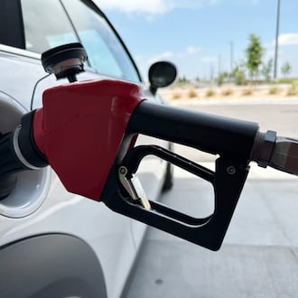 A motorist fills up the tank of a vehicle at a gasoline pump at a Costco warehouse Friday, May 31, 2024, in Aurora, Colo. (AP Photo/David Zalubowski)