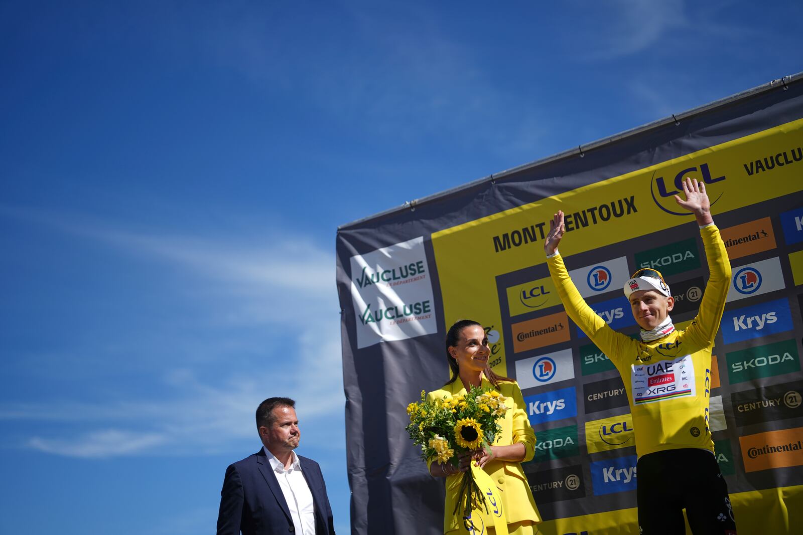 Slovenia's Tadej Pogacar, wearing the overall leader's yellow jersey, celebrates on the podium after sixteenth stage of the Tour de France cycling race over 171.5 kilometers (106.6 miles) with start in Montpellier and finish on the Mont Ventoux, France, Tuesday, July 22, 2025. (AP Photo/Thibault Camus)