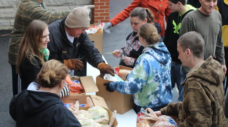 St. Vincent de Paul will hold their 2021 Christmas Basket Program on Dec. 17. Here, volunteers helped distribute food boxes at the annual distribution a couple years ago. Staff