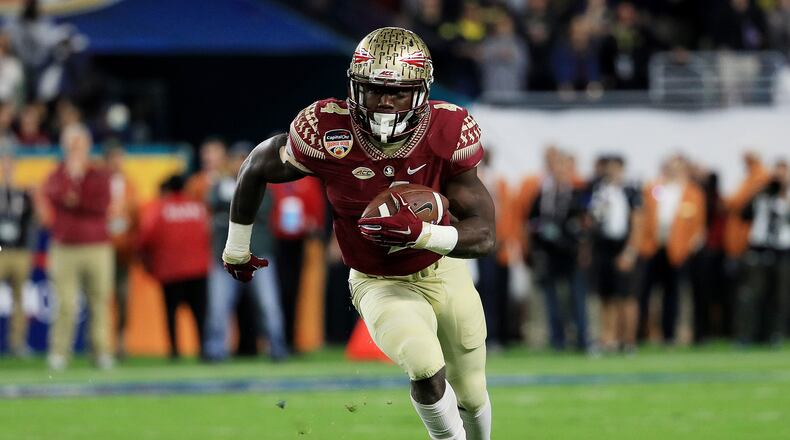 MIAMI GARDENS, FL - DECEMBER 30: Dalvin Cook #4 of the Florida State Seminoles carries the ball in the first quarter against the Michigan Wolverines during the Capitol One Orange Bowl at Sun Life Stadium on December 30, 2016 in Miami Gardens, Florida. (Photo by Mike Ehrmann/Getty Images)