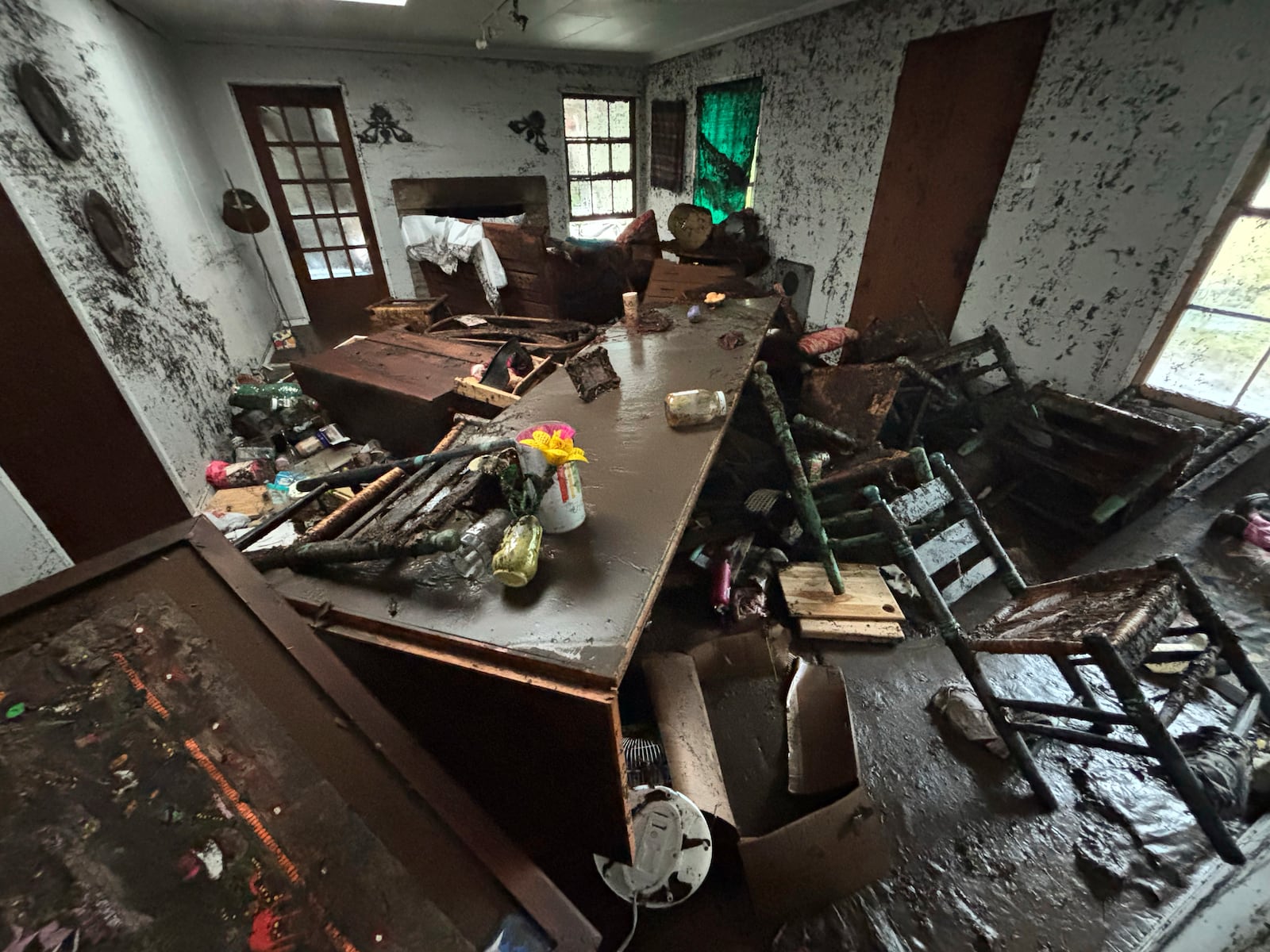 Furniture and personal belongings are covered in mud in Alden Towler's cabin in Hunt, Texas, at 2:37 p.m. on Friday, July 4, 2025, after floodwaters from the Guadalupe River devastated the town. (Alden Towler via AP)