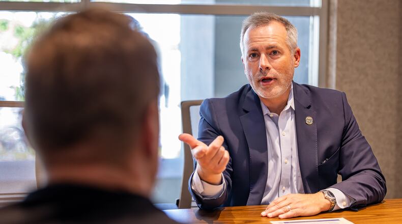 Ohio Treasurer Robert Sprague (right) talks with local business owner A.J. Rolling during a meeting at Dayton Region Manufacturers Association's office in downtown Dayton on Monday, Oct. 6. Sprague is promoting the Buckeye Business Advantage program his office is launching. The program provides low interest loans up to $1 million at a rate 3 percent below current rates over two years for small companies. BRYANT BILLING/STAFF