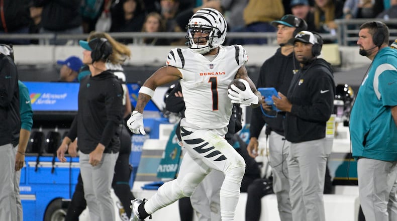 Cincinnati Bengals wide receiver Ja'Marr Chase (1) runs for a touchdown during the second half of an NFL football game against the Jacksonville Jaguars, Monday, Dec. 4, 2023, in Jacksonville, Fla. (AP Photo/Phelan M. Ebenhack)
