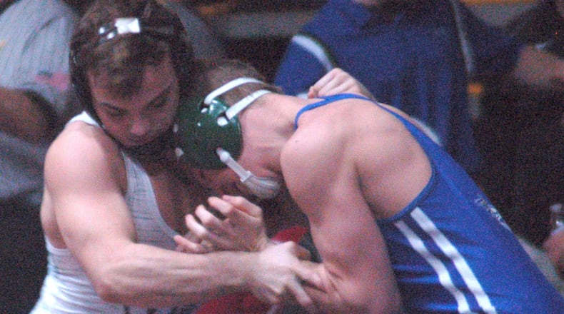 Graham’s Mitch Moore (left) locks up Chaminade Julienne’s Micah Marshall during the 145 pound final Thursday night in the GMVWA Holiday finals at Butler’s SAC. Moore claimed his fourth title with a fall in 2:59. John Cummings/CONTRIBUTED