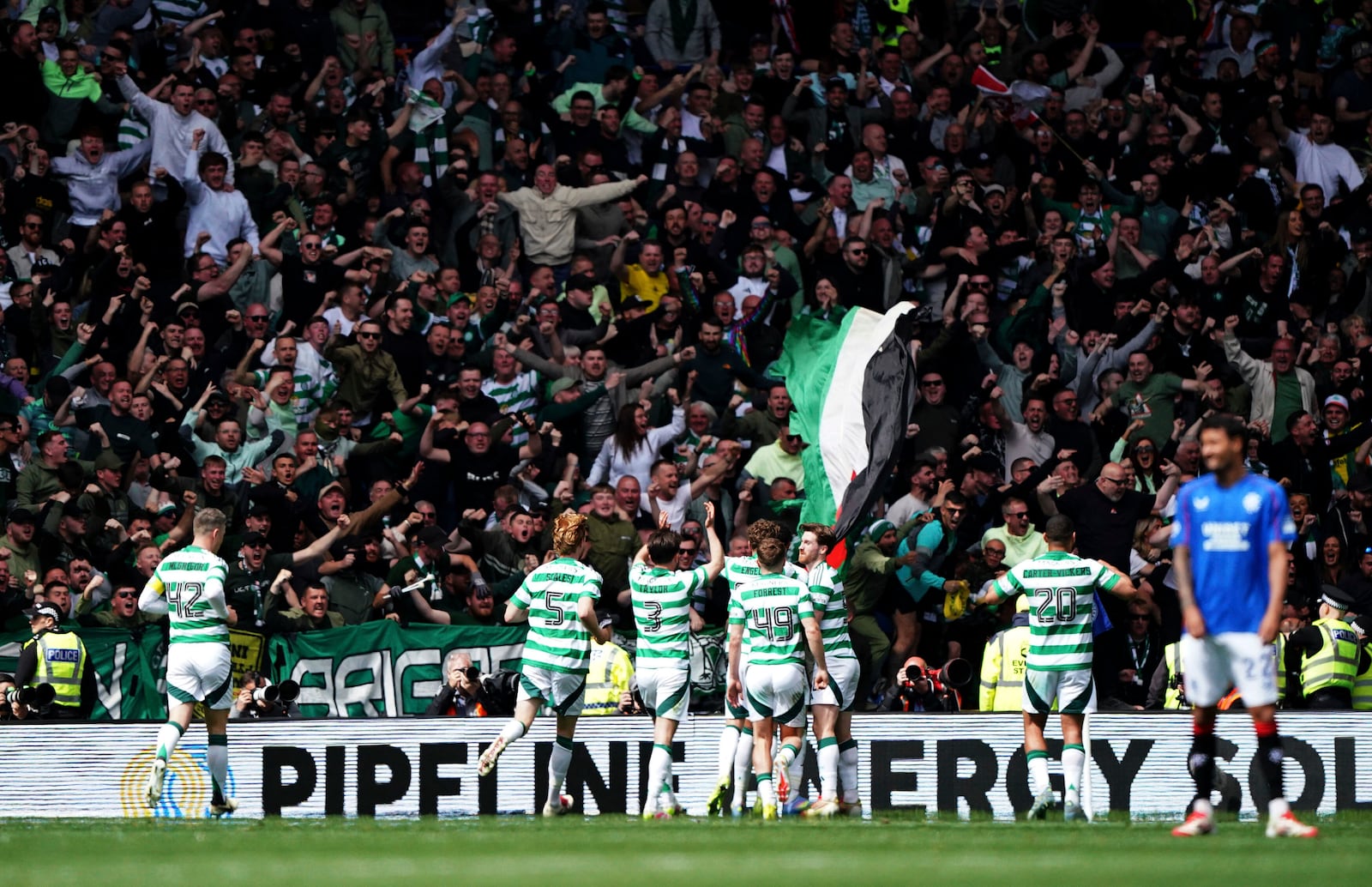Celtic players celebrate after Adam Idah scores their first goal during the Scottish Premiership soccer match between Rangers and Celtic at Ibrox Stadium, Glasgow, Scotland, Sunday, May 4, 2025. (Steve Welsh/PA via AP)
