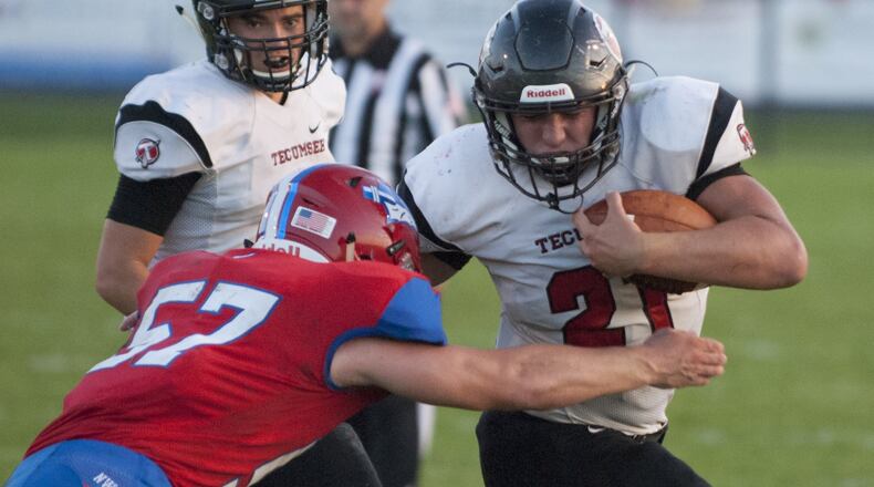 Tecumseh running back Davey Berner tries to fight through a tackle attempt by Northwestern linebacker Nate Snyder during Friday night’s game at Northwestern. Jeff Gilbert/CONTRIBUTED