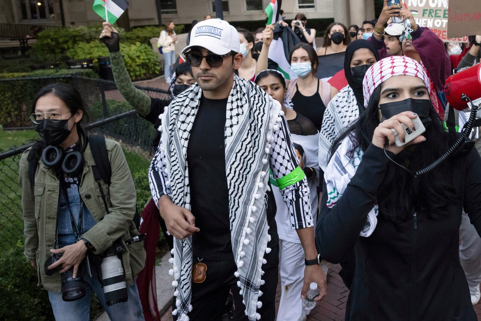 Mohsen Mahdawi, center, looks on during a pro-Palestinian protest at Columbia University, Thursday, Oct. 12, 2023, in New York. (AP Photo/Yuki Iwamura)