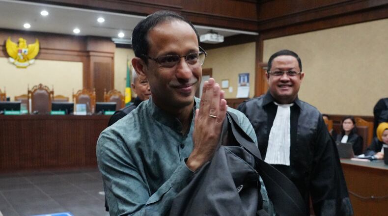 Nadiem Anwar Makarim, the co-founder of Indonesia's payments platform and ride hailing company Gojek and former education minister, reacts as he enters the courtroom for his first trial hearing at the Corruption Court in Jakarta, Indonesia, Monday, Jan. 5, 2026. (AP Photo/Tatan Syuflana)