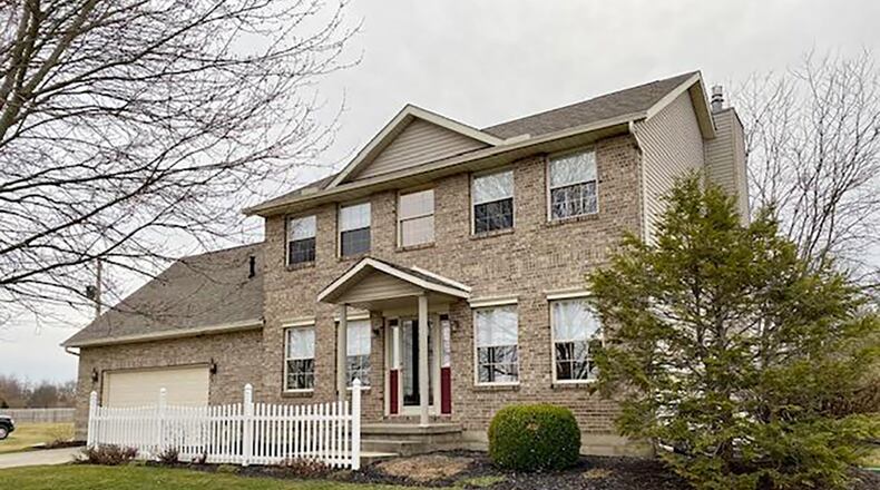 The front of the 2-story home with3 bedrooms and about 1,950 sq. ft. of living space, features a decorative picket fence and concrete walk. CONTRIBUTED PHOTO