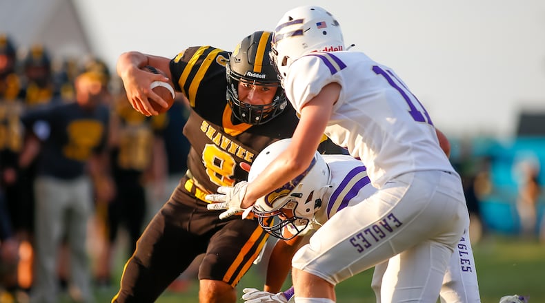 Cutline: Shawnee High School senior Max Guyer runs the ball during their game against Eaton in Springfield earlier this season. CONTRIBUTED PHOTO BY MICHAEL COOPER