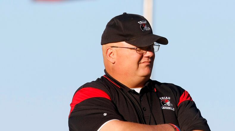 Triad football coach Payton Printz observes his team during warm-ups before a game against Fairbanks in 2012. Staff File Photo
