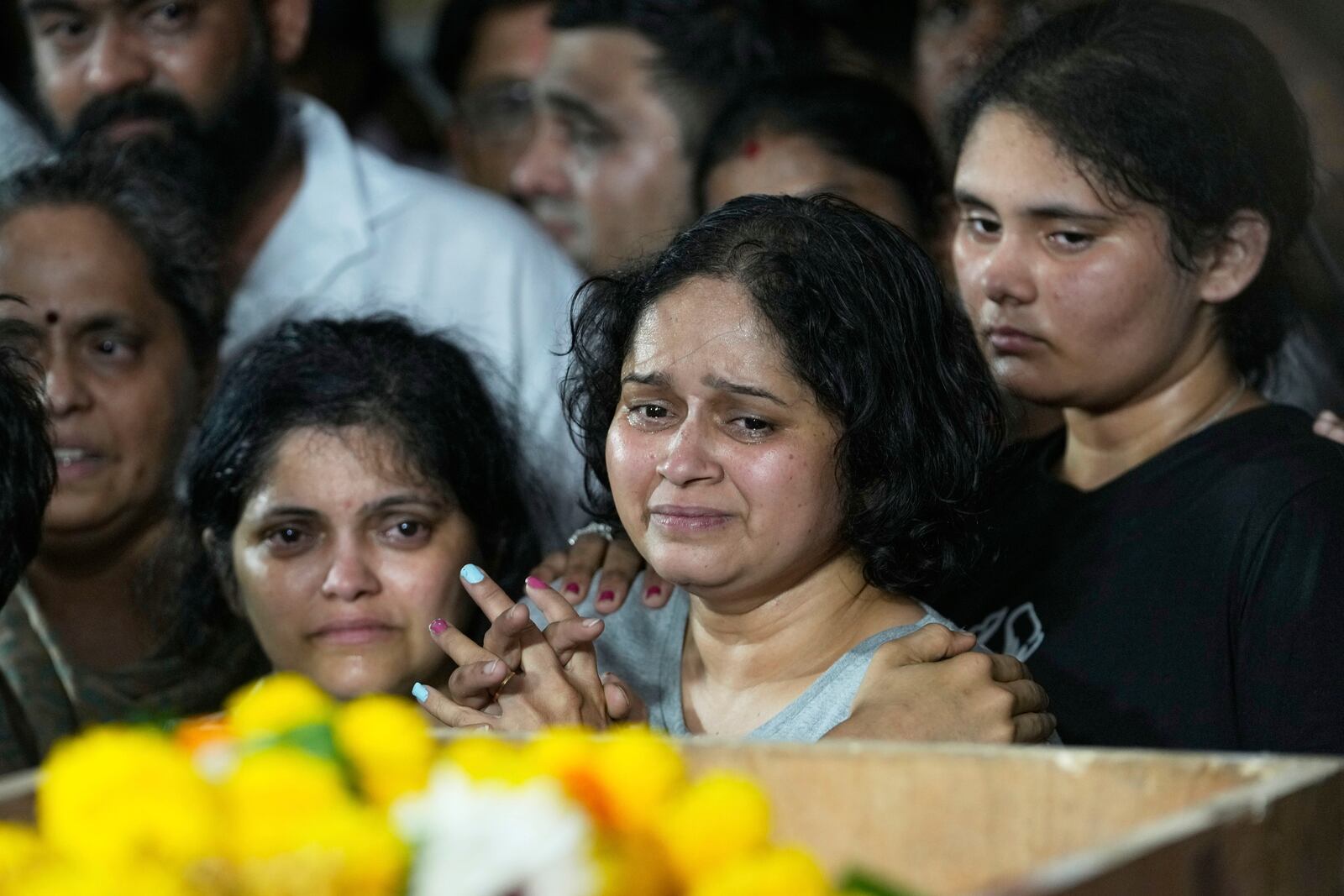 The wife of Atul Mone, who was victim in a deadly attack on tourists in the Pahalgam region of Indian-administered Kashmir, mourns as she stands near her husband's body at Dombivali near Mumbai, India, Wednesday, April. 23, 2025.(AP Photo/Rajanish Kakade)