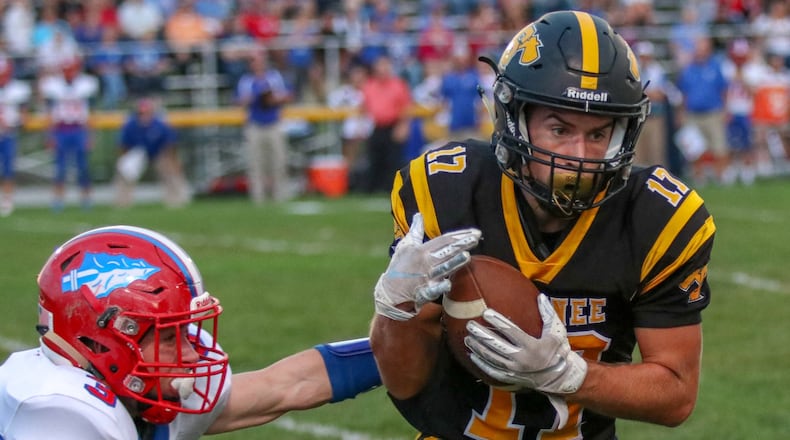 Shawnee High School receiver Pete Mueller catches the ball against Northwestern’s Gavin Thomas during the Braves 40-35 victory in Springfield on Friday night. Michael Cooper/CONTRIBUTED