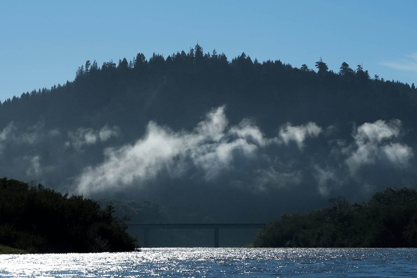 Highway 101 is seen in the distance while traveling on the Klamath River, Thursday, Sept. 19, 2024, in Klamath, Calif. (AP Photo/Godofredo A. Vásquez)