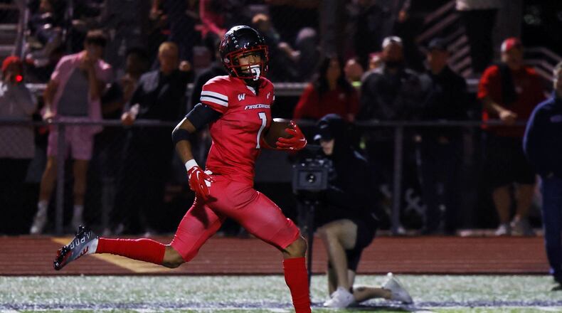 Lakota West defensive back Malik Hartford returns an interception for a touchdown during their football game Friday, Sept. 30, 2022 at Lakota West High School in West Chester Township. Lakota West defeated Mason 37-7. NICK GRAHAM/STAFF
