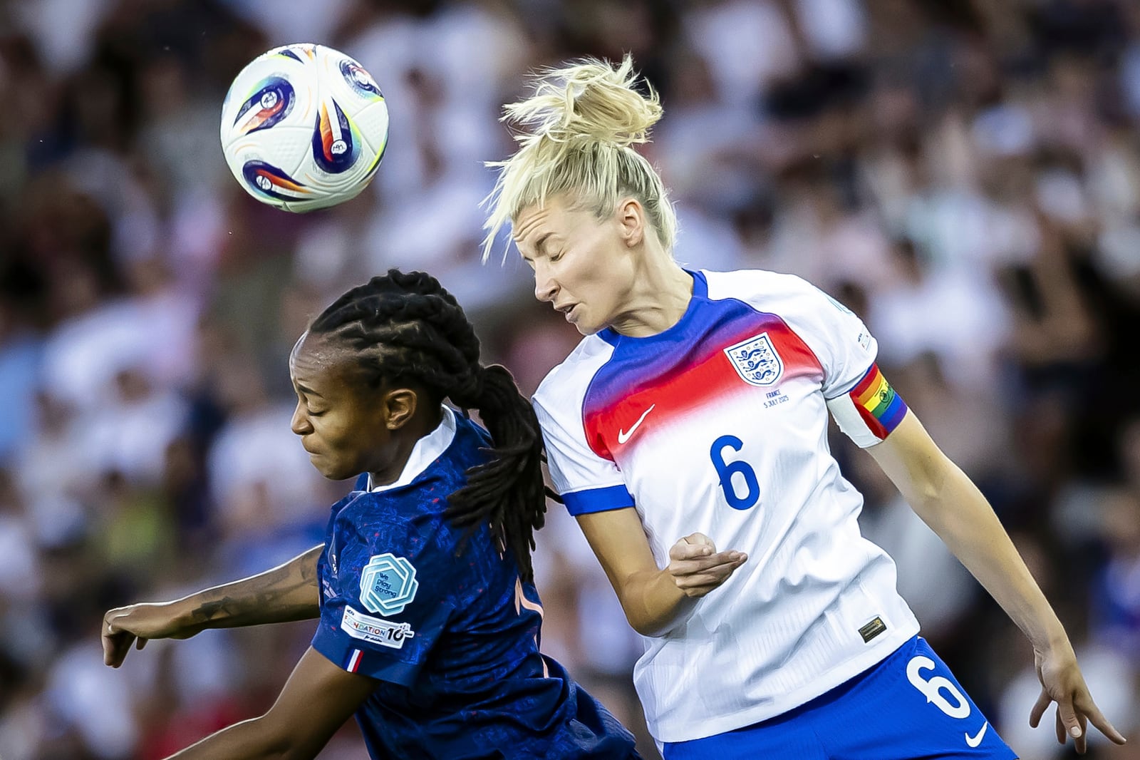 France's Marie-Antoinette Katoto, left, fights for the ball with England's Leah Williamson, right, during the UEFA Women's EURO 2025 Group D soccer match between France and England at the Letzigrund stadium in Zurich, Switzerland, on Saturday, July 5, 2025. (Michael Buholzer/Keystone via AP)