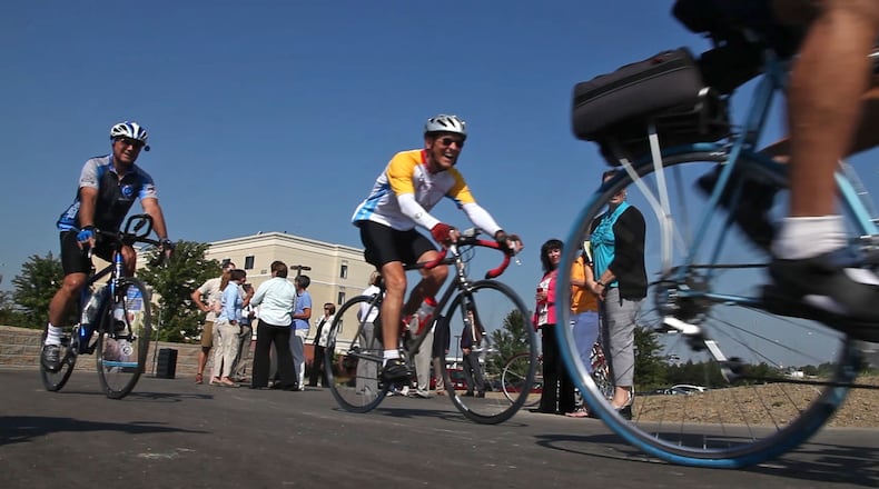 Members of the Dayton Bicycle Club roll away from the Courtyard Marriot Hotel after the official opening of a new 0.7-mile bike path that connects to the region's 300-mile network of connected, paved trails at the Stewart Street Bridge. The Miami Valley Regional Planning Commission is updating the regional bikeways plan. And it wants your opinion.